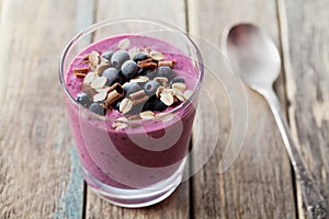 Healthy breakfast of smoothie, dessert, yogurt or milkshake with frozen berry and oats decorated grated chocolate