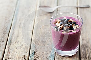 Healthy breakfast of smoothie, dessert, yogurt or milkshake with frozen berry and oats decorated grated chocolate