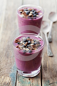 Healthy breakfast of smoothie, dessert, yogurt or milkshake with frozen berry and oats decorated grated chocolate