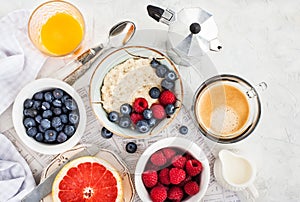 Healthy breakfast table with oatmeal porridge, fresh berries an