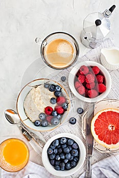 Healthy breakfast table with oatmeal porridge, fresh berries an