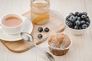 healthy breakfast: tea with cake, honey and fresh blueberry/healthy breakfast: tea with cake, honey and fresh blueberry on a