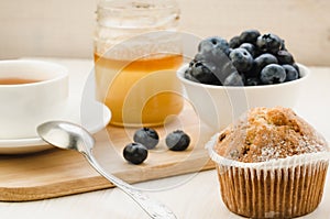 healthy breakfast: tea with cake, honey and fresh blueberry/healthy breakfast: tea with cake, honey and fresh blueberry on a