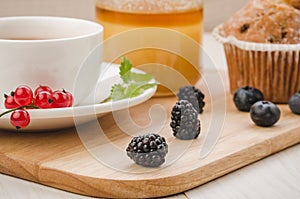 healthy breakfast: tea with fresh berries, cake and honey/healthy breakfast: tea with fresh berries, cake and honey. Selective