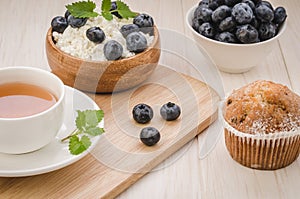 healthy breakfast: tea with mint, cottage cheese, cake and fresh berries/healthy breakfast: tea with mint, cottage cheese, cake