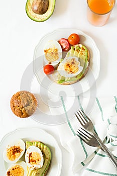 Healthy breakfast: toasts with avocado slices, tomato, paprika and eggs