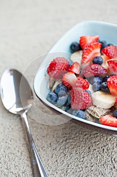 Healthy breakfast with toppings with spoon