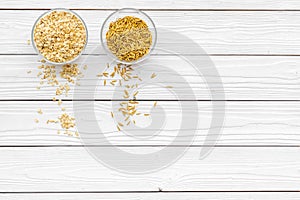 Healthy breakfast. Various cereals in bowls on white wooden background top view copy space