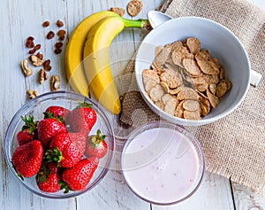 Healthy Breakfast which included cornflakes and oatflakes, yogurt, bananas photo