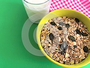 Healthy Breakfast whole grain oat cereal with seeds and glass of milk