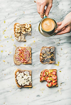 Healthy breakfast with wholegrain toasts , woman`s hands with coffee