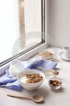 Healthy breakfast on window sill homemade granola with nuts