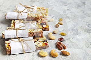 Healthy granola bars with dry fruits, nuts on wooden background.