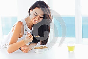 Healthy breakfast. Woman smiling and enjoying morning