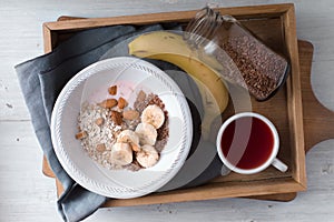 Healthy breakfast on the wooden tray top view