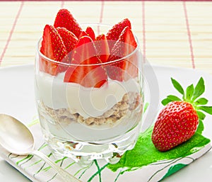 Healthy breakfast - yoghurt with granola and strawberries