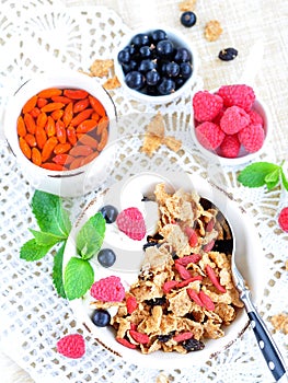 Healthy breakfast, yogurt with granola and berries on the white table