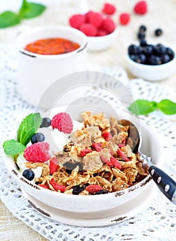 Healthy breakfast, yogurt with granola and berries on the white table