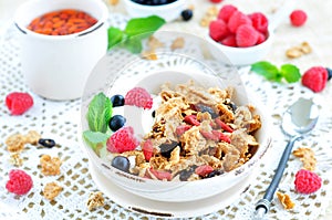 Healthy breakfast, yogurt with granola and berries on the white table