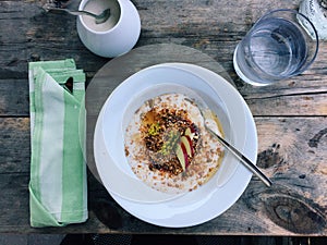 Healthy breakfast: yogurt with granola and fruit on wooden table