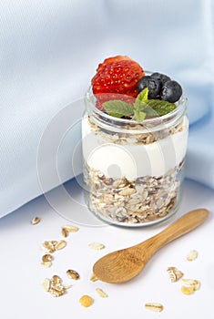 Healthy breakfast with yogurt, muesli, berries and strawberries