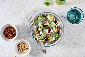 healthy broccoli salad with feta cheese sun dried tomatoes pine nuts.. vegetarian low carb keto diet