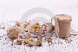 healthy brown smoothie with walnut and candied fruits lie on the