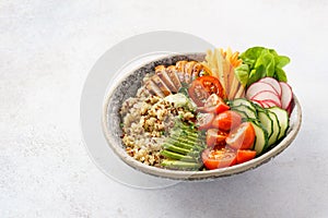 Healthy buddha bowl with chicken, quinoa and fresh vegetables