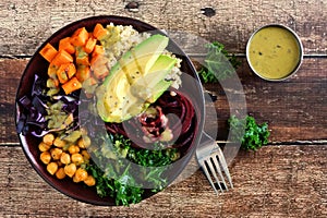 Healthy Buddha bowl on a wood background. Top view. photo