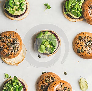 Healthy burgers with beetroot patties and green sprouts, top view