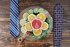 Healthy business lunch concept with ties and citrus fruits