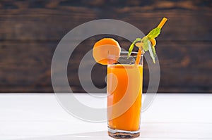 Healthy carrot smoothie served in a tall glass