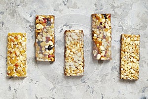 Healthy cereal bars on texture table, with copy space top view