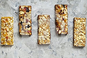 Healthy cereal granola bars with nuts and dry berries close up.