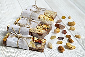 Healthy cereal granola bars with nuts and dry berries close up.