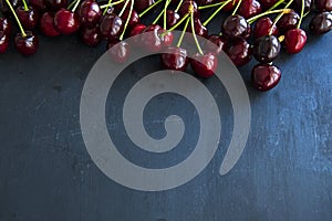 Healthy cherry fruits on a black slates, isolated