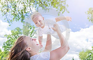 Healthy child (kid) having fun with mother in the sunny summer day. Caucasians happy baby (boy). photo