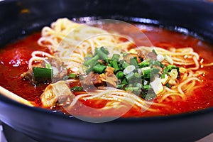 Healthy Chinese Tomato Beef Noodle Soup in Large Bowl.