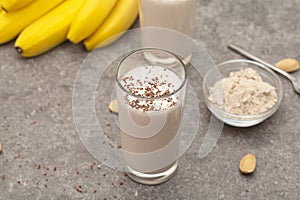 Healthy chocolate banana protein shake with almond milk in a glass.