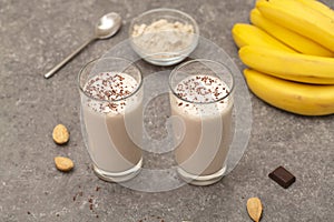 Healthy chocolate banana protein shake with almond milk in a glass.