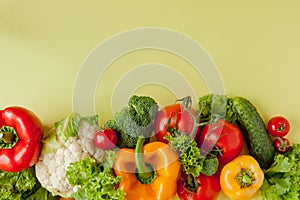 Healthy clean eating layout, vegetarian food and diet nutrition concept. Various fresh vegetables ingredients for salad on yellow