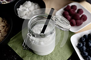 Healthy coconut rice drink with coconut flakes in mason jar with straw