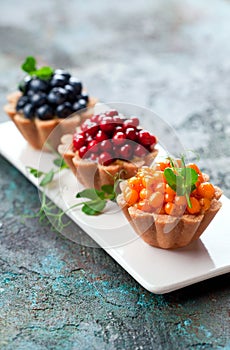Healthy coconut tartlets with custard and fresh berries