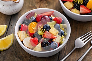 Healthy and colorful fruit salad with orange dressing and fresh mint