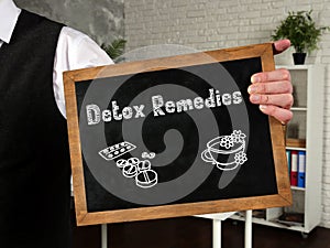 Healthy concept meaning Detox Remedies with sign on the piece of paper
