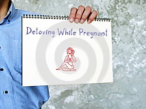 Healthy concept meaning Detoxing While Pregnant with phrase on the sheet