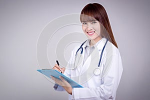 Healthy concept : Young Asian doctor writing on clipboard for patient chart.