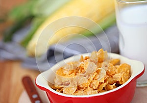 Healthy continental breakfast consists of cup of milk,Red bowl o