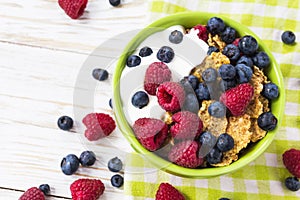 Healthy corn flakes breakfast on the white wooden table