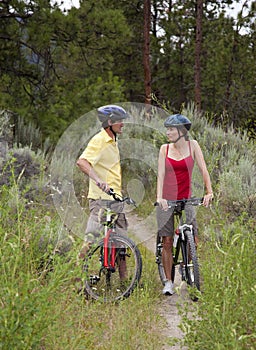 Healthy Couple on Bikes in a Forest